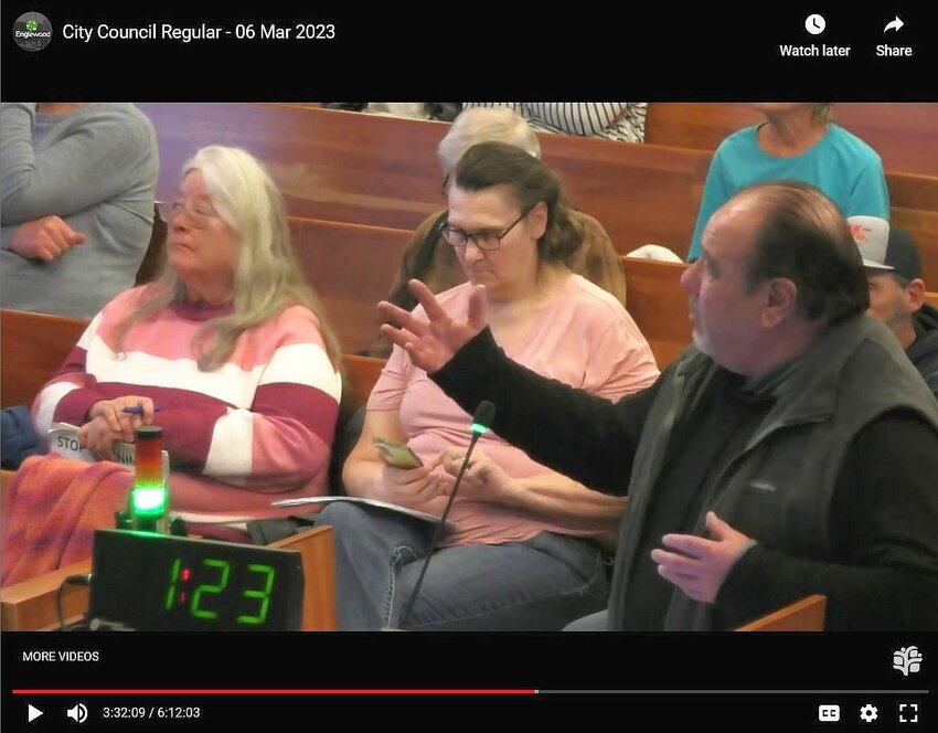 Mike Chavez, right, the majority owner of Sam's Automotive, gestures at a screen while speaking to Englewood City Council on March 6, 2023, at the public hearing for the rezoning of the Sam's lot at Oxford Avenue and Navajo Street.